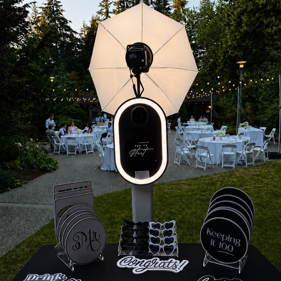 Pop Up Photo Booth setup with ring light and umbrella lighting at an outdoor wedding reception