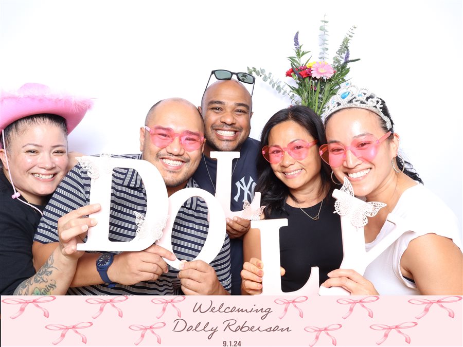 Group celebrating and welcoming baby Dolly Roberson at a baby shower photo booth