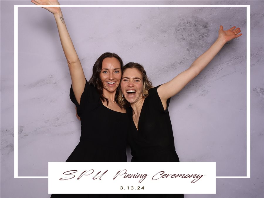 Graduates celebrating at the SPU Pinning Ceremony photo booth