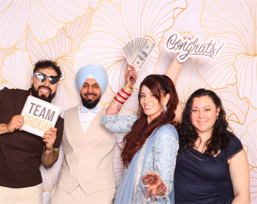 The groom posing with his bride at the Khattras wedding photo booth