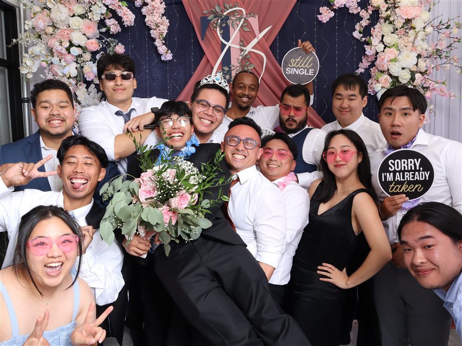 Wedding party posing with a Still Single sign at Theresa and Trung's wedding photo booth