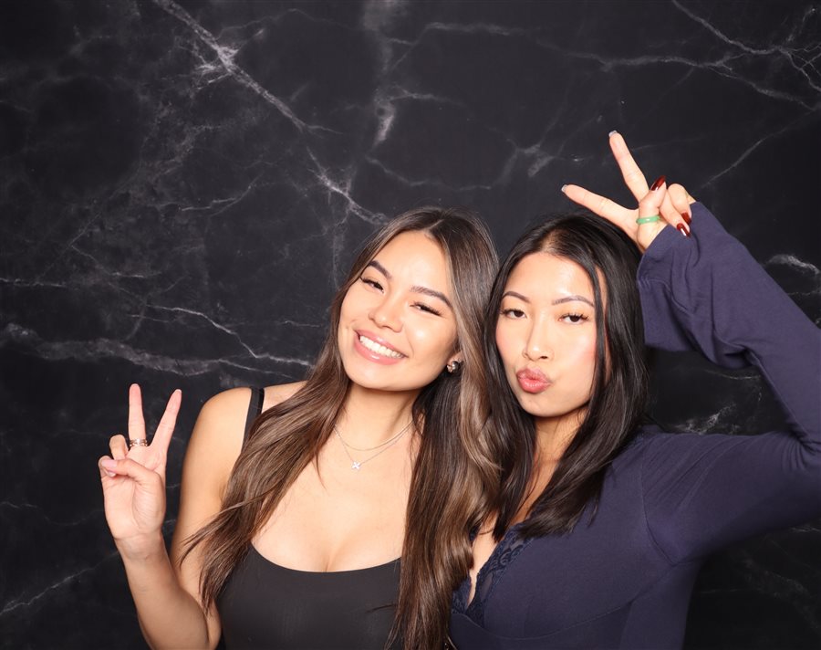 Friends posing together at Tony's birthday photo booth